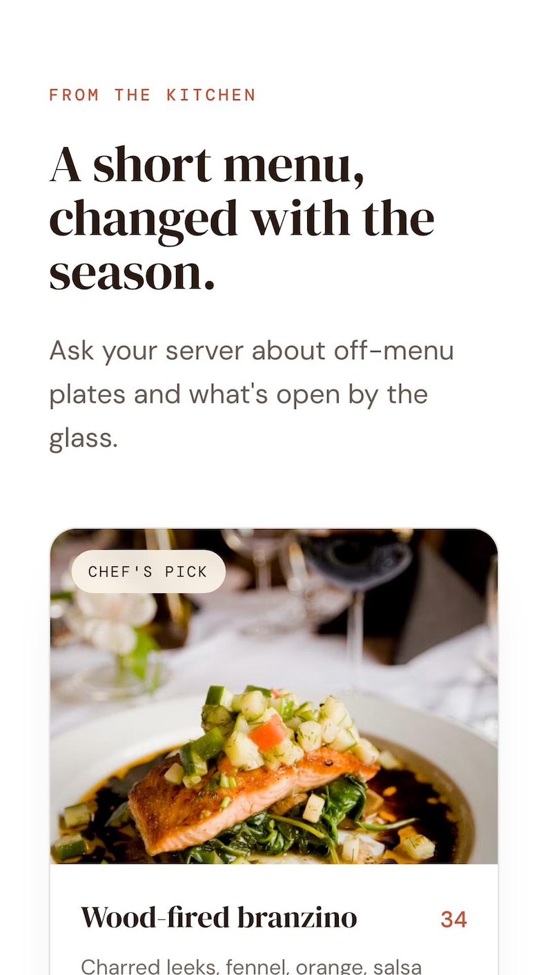 May include: A restaurant menu page featuring the text FROM THE KITCHEN, A short menu, changed with the season, and Ask your server about off-menu plates and what's open by the glass. Below is a photo of wood-fired branzino with a CHEF'S PICK label.