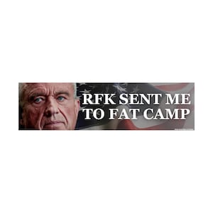May include: Bumper sticker with the text "RFK SENT ME TO FAT CAMP" in white letters. The background features an American flag and a close-up of a man's face. The sticker is rectangular.