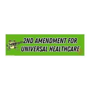 May include: A green bumper sticker with the text "2ND AMENDMENT FOR UNIVERSAL HEALTHCARE" in bold white letters. A cartoon frog holding a rifle is on the left. A red target is on the right.