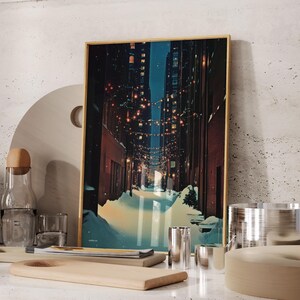 May include: A framed art print depicts a winter alleyway scene with snow and string lights. The artwork has a gold frame and is displayed with wooden cutting boards, glassware, and metal containers. The color palette includes blues, browns, and yellows.