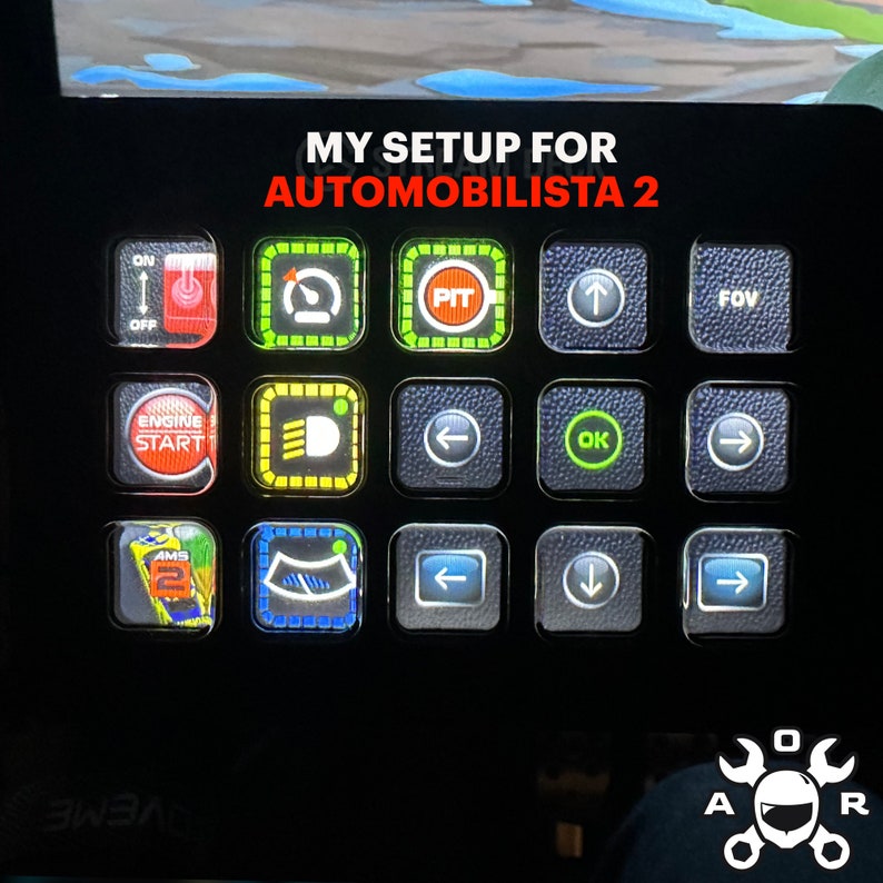 May include: A black control panel with a white label that reads "MY SETUP FOR AUTOMOBILISTA 2". The panel has 12 buttons with various symbols and text, including "PIT", "FOV", "OK", and arrows.