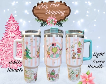 May include: Three 40oz stainless steel tumblers with a Christmas Grinch theme. The tumblers have a pink and white striped design with a Grinch and other characters. One tumbler has a white handle, one has a light green handle, and one has a turquoise handle.