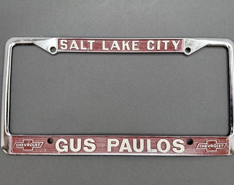 Vintage Gus Paulos Chevrolet License Plate Frame Salt Lake City Utah Cast Metal