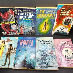 May include: A set of three ceramic mugs with a speckled, cream-colored glaze. Each mug features a different hand-painted floral design in shades of blue, green, and yellow. The mugs have a simple, rounded shape and a comfortable handle.