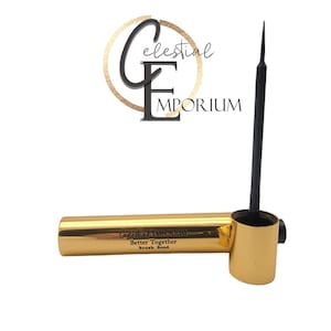 May include: Gold eyeliner pen with a black felt tip applicator. The pen has the words "Better Together" and "Brush Bond" printed on it.