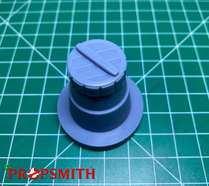 May include: A light blue plastic model of a cylindrical container with a lid. The lid has a grooved design and a small handle.