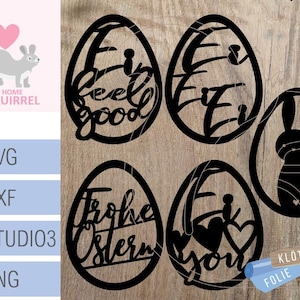 Peut inclure: Cinq découpes en forme d'œuf de Pâques noires et blanches avec des motifs différents. Les motifs comprennent "feel good", "I love you", "Frohe Ostern", un lapin et un œuf à motifs.