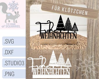 May include: Black and white silhouette design of a Christmas sign with the text "Frohe Weihnachten" and "Für Klötzen". The sign is on a wooden base and surrounded by a brown woodgrain background.