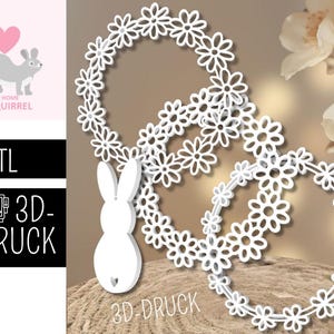 Könnte beinhalten: Weiße 3D-gedruckte Gänseblümchen-Blumenkränze mit einem Hasen-Ausschnitt. Die Kränze sind in einem geschichteten Design angeordnet. Das Bild enthält auch den Text '.STL' und '3D-DRUCK'.