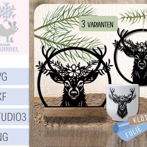 May include: Black deer head silhouette with floral antlers, displayed in a circular frame. The image includes a mug and a hanging ornament with the same design. The text "3 VARIANTEN" is visible.