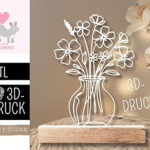 Puede incluir: Un arreglo floral blanco impreso en 3D en un jarrón, iluminado sobre una base de madera. El diseño presenta delicados contornos de flores. El texto a la izquierda dice '.STL' y '3D-DRUCK'.