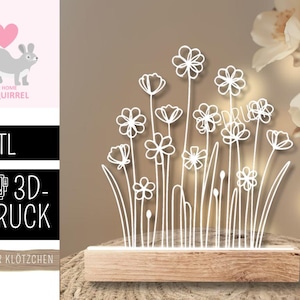 May include: A white floral design, possibly a lamp or decoration, is mounted on a wooden base. The design features stylized flowers and stems. The background is a neutral color, and the overall aesthetic is minimalist and modern.
