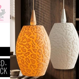 May include: Two pendant lights with textured, oval-shaped shades. One is orange with a leopard-like pattern, the other is white with a leaf-like design. Both have wooden tops and hang from thin cords, suitable for home decor.