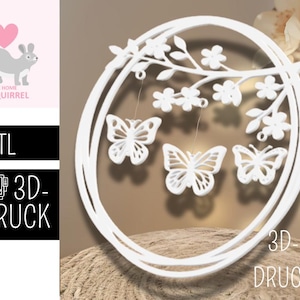 以下が含まれることがあります： 白い円形の壁の装飾で、花と3匹のぶら下がっている蝶が付いた枝が特徴です。デザインは3Dプリントされています。画像には、リスのグラフィックとテキスト「.STL」および「3D-DRUCK」も含まれています。