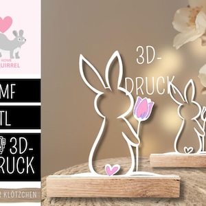 Può includere: Statuine di conigli bianchi stampate in 3D che tengono tulipani rosa, poste su basi di legno. Il design include un dettaglio a cuore e il testo "3D-DRUCK". L'immagine presenta anche una grafica di scoiattolo con la scritta "THE HOME of SQUIRREL".