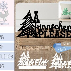 Könnte beinhalten: Ein schwarz-weißes digitales Design mit zwei stilisierten Weihnachtsbäumen mit dem Text "Annschen Bitte" in einer dekorativen Schriftart. Das Design befindet sich auf einem Holzgrund mit den Worten "Klötzchen Folie" in einer kleineren Schriftart.