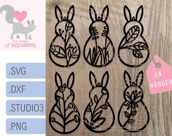 May include: Six black silhouette bunny rabbit cutouts with floral designs. The bunnies are arranged in two rows of three. The text "AN-HÄNGER" is in the upper right corner of the image.