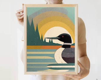 May include: A framed print of a stylised loon with a black and white patterned body, red eyes, and a black beak. The loon is swimming in a blue and green lake with a yellow sun and green trees in the background.