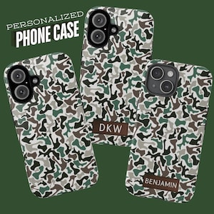 May include: Three phone cases featuring a camouflage pattern in shades of green, brown, white, and black. Two cases include a brown rectangular patch with the text DKW or BENJAMIN. The text PERSONALIZED PHONE CASE appears in the upper left corner.