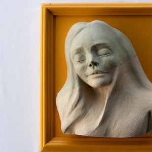 Handmade Woman Bust Sculpture: Figurative Clay Art in Yellow Wooden Frame