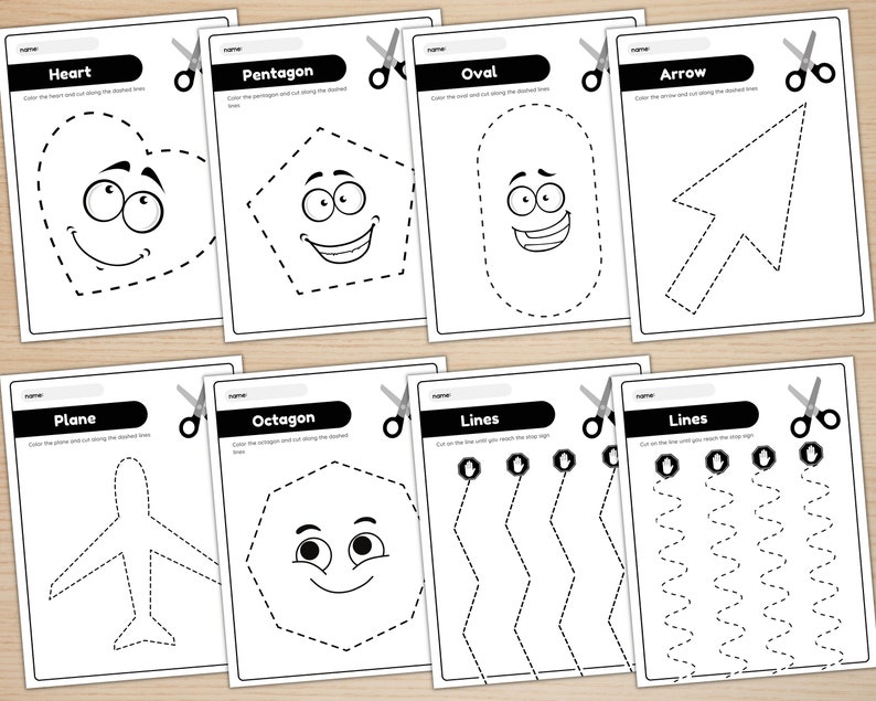 May include: Black and white printable worksheet with cut-out shapes for kids. The shapes include a heart, pentagon, oval, arrow, plane, octagon, and lines. Each shape has a dotted line for cutting and a smiling face.