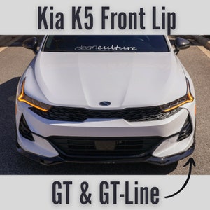 May include: White Kia K5 with a black front lip spoiler. The car has a black grille and black side mirrors. The text "cleanculture" is visible on the windshield. The text "GT & GT-Line" is visible below the car.
