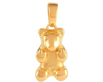May include: A gold-coloured gummy bear pendant charm. The bear is standing upright with its arms raised and its head tilted slightly forward. The pendant is perfect for adding a playful touch to any jewellery piece.