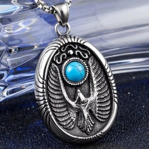 May include: Silver pendant necklace with a turquoise stone and an eagle design.
