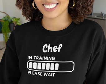 May include: Black sweatshirt with white text that reads "Chef in training" with a progress bar and the words "Please wait".