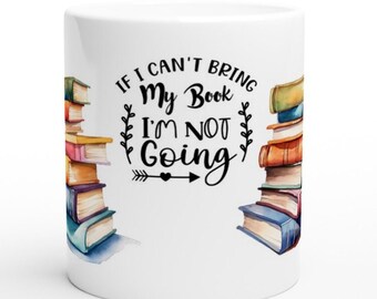 May include: White ceramic mug with a black and white graphic that reads "If I can't bring my book I'm not going". The graphic is surrounded by a watercolor illustration of a stack of books on each side of the mug.