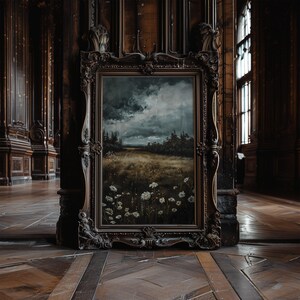 May include: An antique wooden frame with a dark brown finish holds a painting of a landscape with a cloudy sky and a field of white flowers.