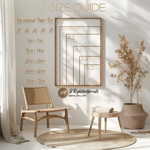May include: A size guide for prints, showing different sizes of paper in centimeters. The sizes are A1, A2, A3, A4, and A5. The largest size is 50 cm x 70 cm. The smallest size is 5 cm x 7 cm. The guide is on a white wall with a wooden chair and a stool in front of it.