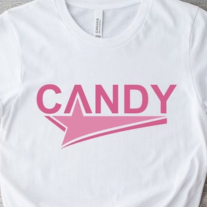 Może przedstawiać: Biała koszulka z różową gwiazdą i napisem "CANDY" w różowych literach.