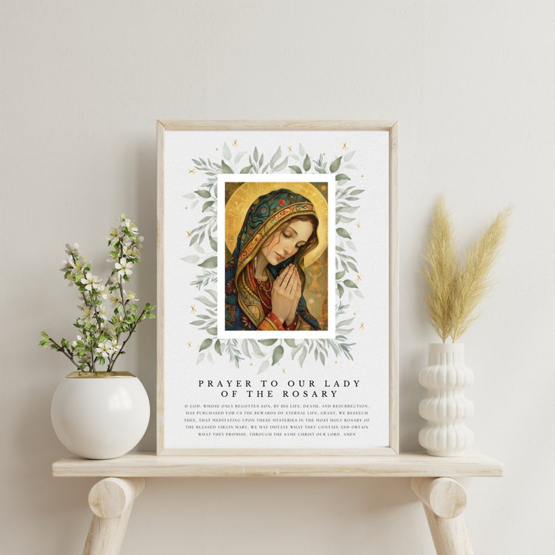 May include: A printable prayer to Our Lady of the Rosary featuring a watercolor illustration of the Virgin Mary with a green leafy border. The text reads "PRAYER TO OUR LADY OF THE ROSARY O GOD, WHOSE ONLY BEGOTTEN SON, BY HIS LIFE, DEATH, AND RESURRECTION, HAS PURCHASED FOR US THE REWARDS OF ETERNAL LIFE, GRANT, WE BESEECH THEE, THAT MEDITATING UPON THESE MYSTERIES IN THE HOLY ROSARY OF THE BLESSED VIRGIN MARY, WE MAY IMITATE WHAT THEY CONTAIN AND OBTAIN WHAT THEY PROMISE, THROUGH THE SAME CHRIST OUR LORD. AMEN"
