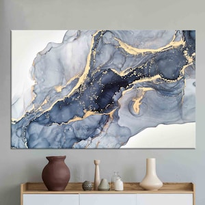 May include: Abstract art print featuring a swirling pattern of blue and grey hues with gold accents. The print has a modern and minimalist aesthetic.