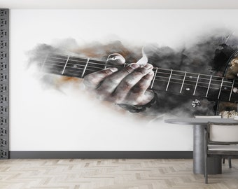 May include: A watercolor painting of a hand playing a guitar, with a blurred background of a wooden table and chairs. The painting is in shades of gray and brown.