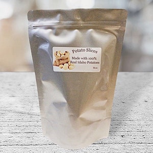 May include: A silver resealable bag of potato slices. The bag has a label that reads "Potato Slices Made with 100% Real Idaho Potatoes 12 oz."