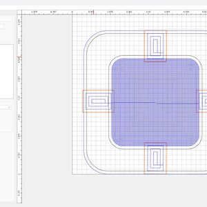 May include: Screenshot of a computer program interface. The interface displays a design with a blue rectangular shape, surrounded by a rounded square outline. Several orange and red rectangular shapes are also visible. The program's menu is on the left.