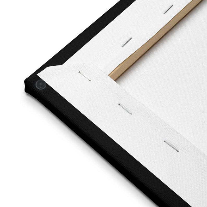 May include: Close-up of the back of a canvas print, showing the black frame and white canvas stretched over a wooden frame. The canvas is secured with staples.