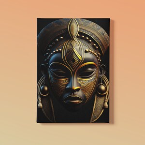 May include: A canvas print featuring a stylized African mask. The mask is primarily black with intricate gold-colored details, including the headdress, facial features, and decorative elements. The artwork has a three-dimensional appearance.