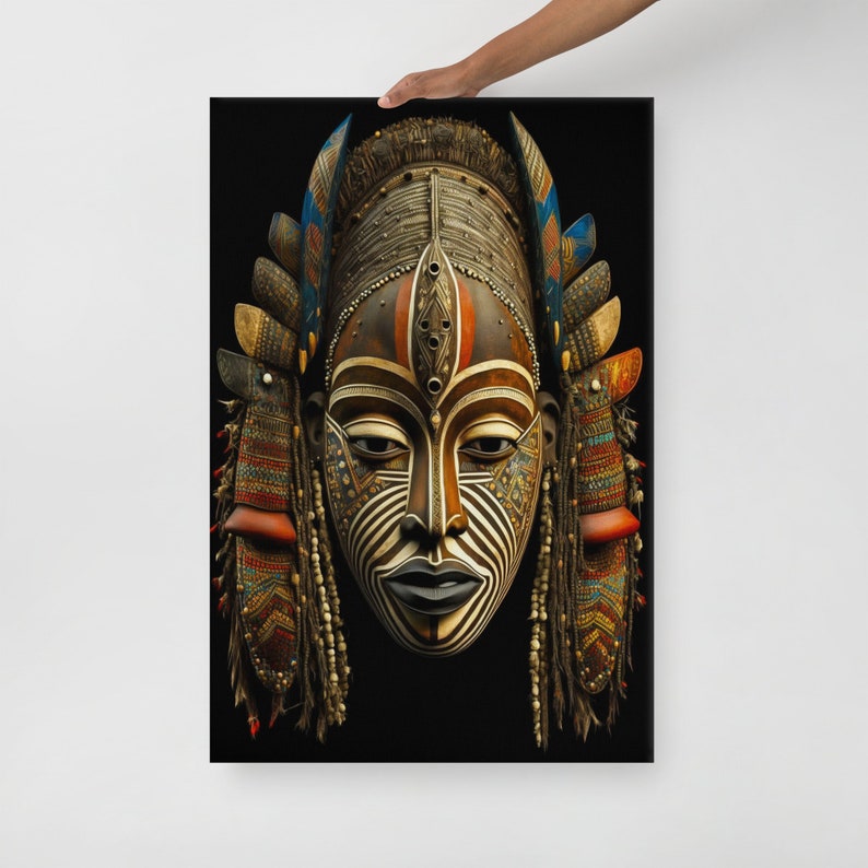 May include: A wooden African mask with intricate details. The mask is painted in black, white, brown, red, and blue. It has a long, narrow face with a pointed chin and a wide, flat forehead. The eyes are almond-shaped and the nose is long and thin. The mouth is slightly open and the lips are full. The mask is decorated with beads and feathers.