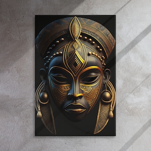 May include: A canvas print featuring a stylized African mask. The mask is primarily black with intricate gold-colored details, including geometric patterns and decorative elements. The mask has a serene expression and is framed on a dark background.