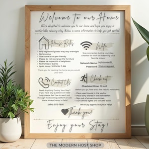 May include: A framed sign with a wooden frame, featuring the text "Welcome to our Home." The sign includes house rules, Wi-Fi information, contact details, and checkout instructions. The sign is designed for a rental property.