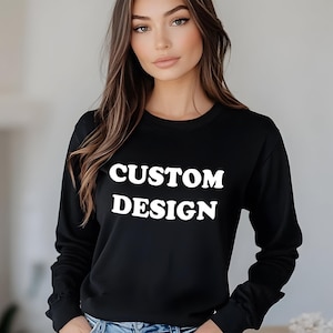 May include: Black long-sleeve sweatshirt with the text "CUSTOM DESIGN" in white.