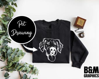Könnte beinhalten: Schwarzes Sweatshirt mit einer weißen Umrandung eines Hundekopfes. Der Text "Pet Drawing" befindet sich auf einem schwarzen Kreis in der oberen linken Ecke des Bildes.