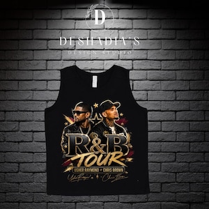 May include: A black tank top featuring a graphic print of Usher and Chris Brown. The design includes the text R&B TOUR, USHER RAYMOND X CHRIS BROWN, and stylized signatures. The graphic is accented with gold stars and brushstroke elements.