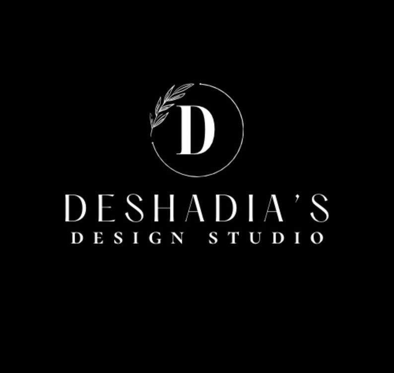 May include: A black background with the white text "DESHADIA'S DESIGN STUDIO". The logo features a white letter "D" inside a circle, with a leaf design. The overall design is minimalist and elegant.