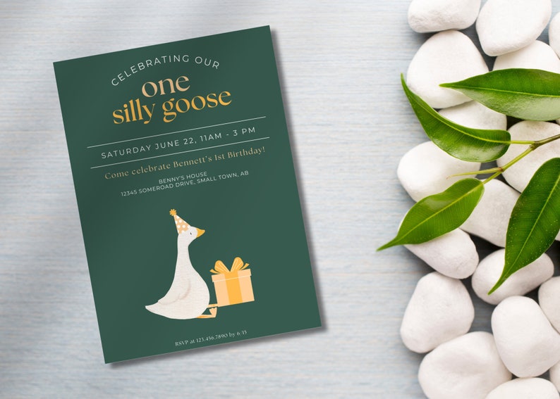 May include: A green invitation card with a white goose wearing a party hat and holding a yellow gift box. The text on the card reads "Celebrating our one silly goose" and "Saturday June 22, 11am - 3pm. Come celebrate Bennett's 1st Birthday! Benny's House 12345 Somerood Drive, Small Town, AB. RSVP at 121.456.7890 by 6/15"