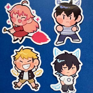 May include: Four cartoon stickers on a blue background. The stickers depict chibi-style characters with different expressions and outfits. One character has pink hair and a red dress, another has black hair and a striped top, and two others have blonde and black hair.