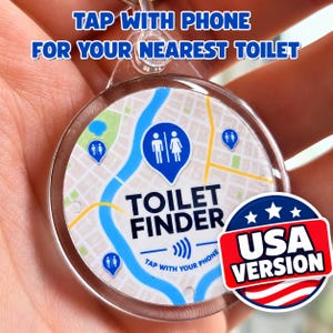 May include: A round, clear plastic keychain featuring a map graphic with blue toilet location pins. The text reads TAP WITH PHONE FOR YOUR NEAREST TOILET, TOILET FINDER, and TAP WITH YOUR PHONE. A red, white, and blue USA VERSION badge is attached.